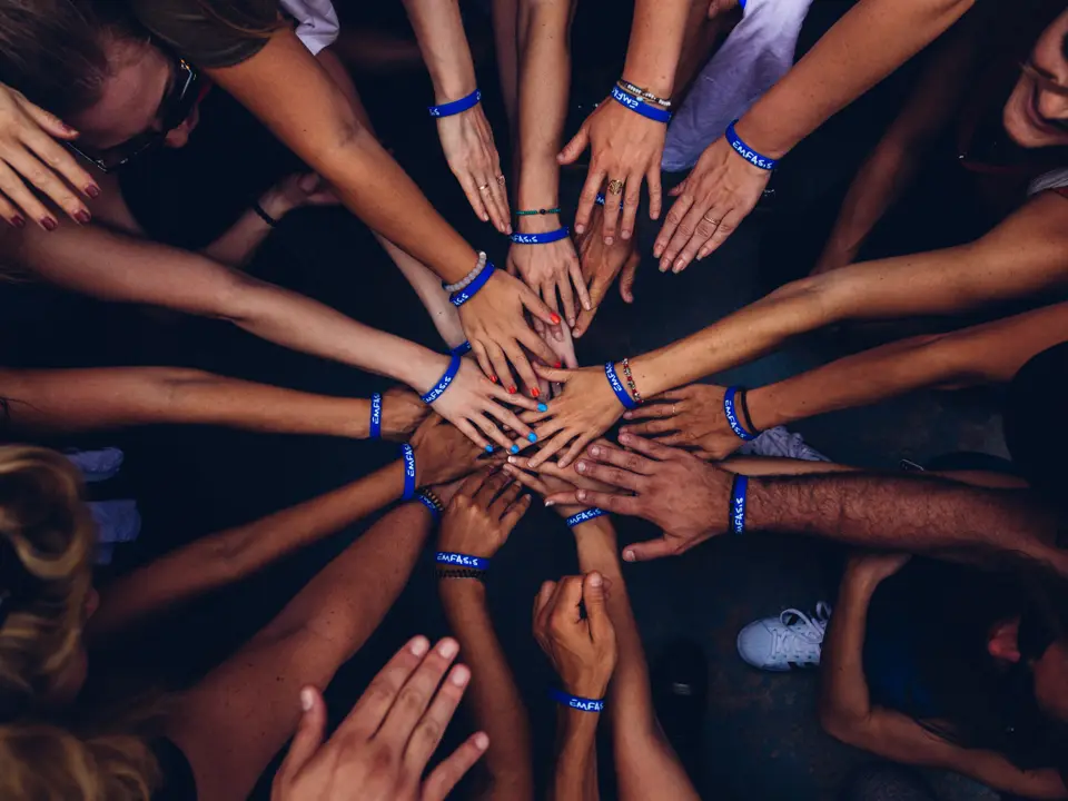 Team Coaching: team members joining hands